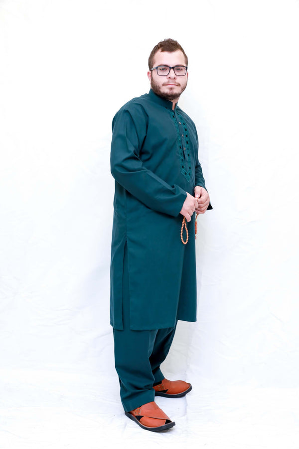 A dark green shirt with minimal embroidery in the same color and loose dark green pants. Men Green Cotton Salwar Kameez