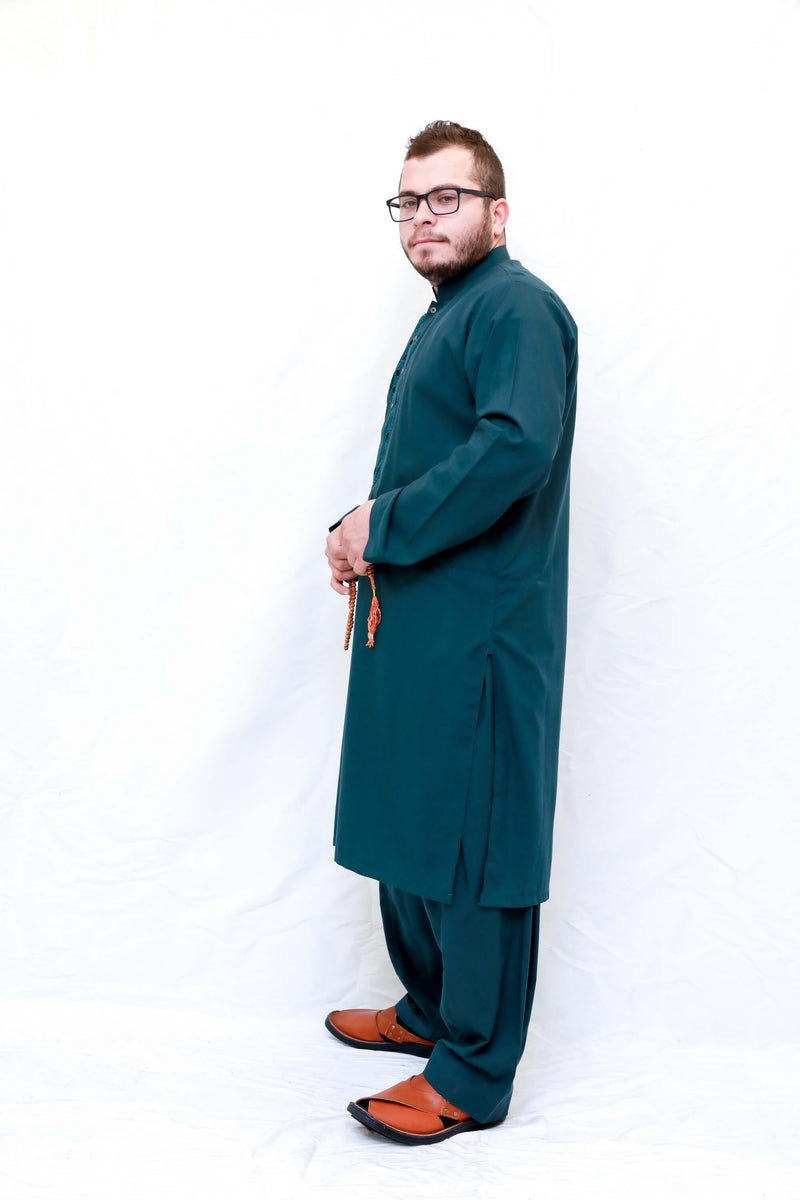 A dark green shirt with minimal embroidery in the same color and loose dark green pants. Men Green Cotton Salwar Kameez